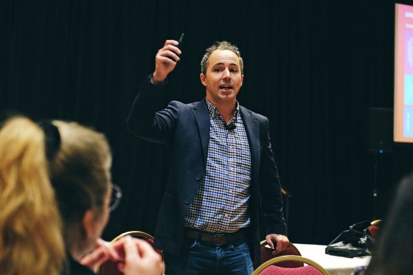 A man engages with a group, emphasizing teamwork and inclusivity in a session focused on enhancing workplace culture.